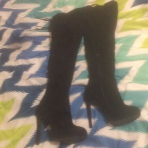 Thigh high black suede heels.